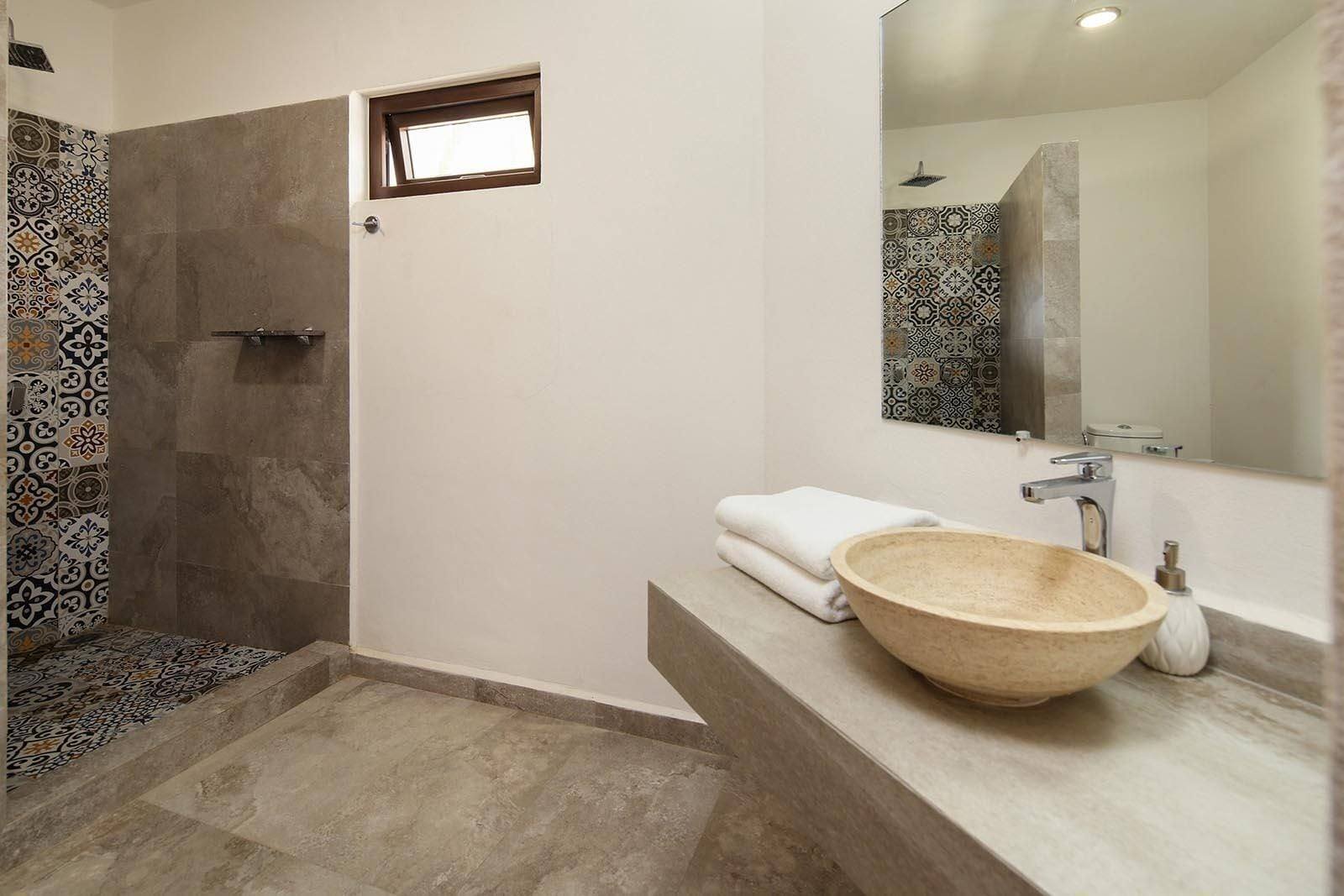 Casa Di Giulio: bathroom with a large mirror and a shower with patterned tiles