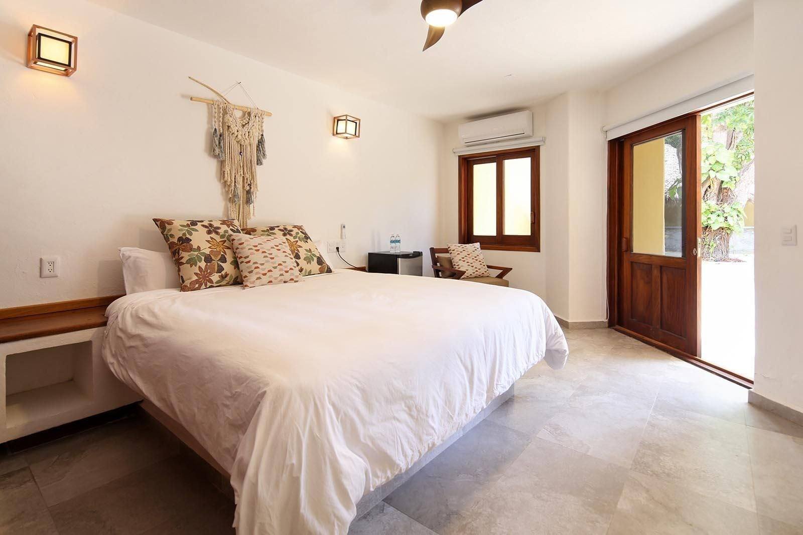 Casa Di Giulio: room with a large bed and a window onto the garden